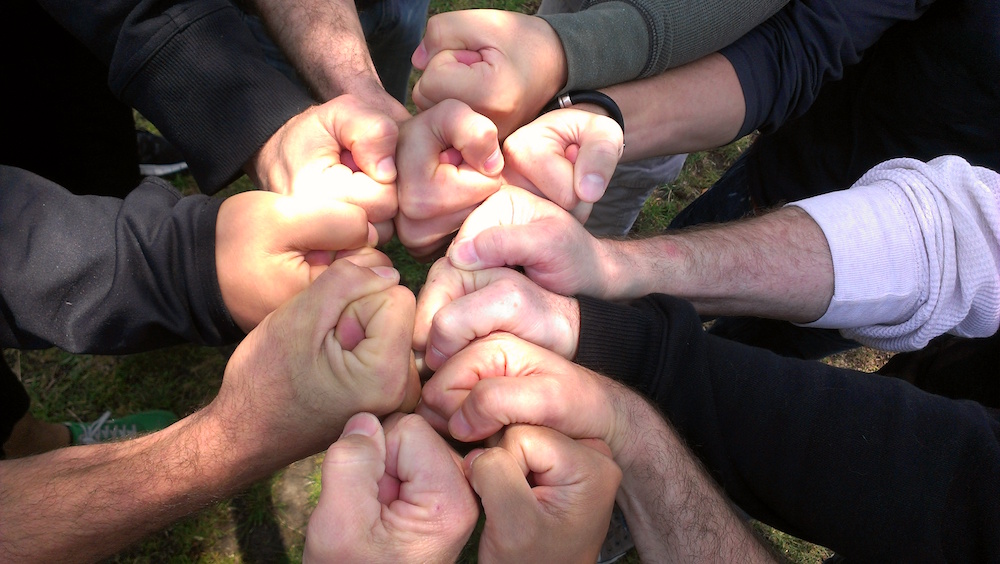 Men's hands in a circle